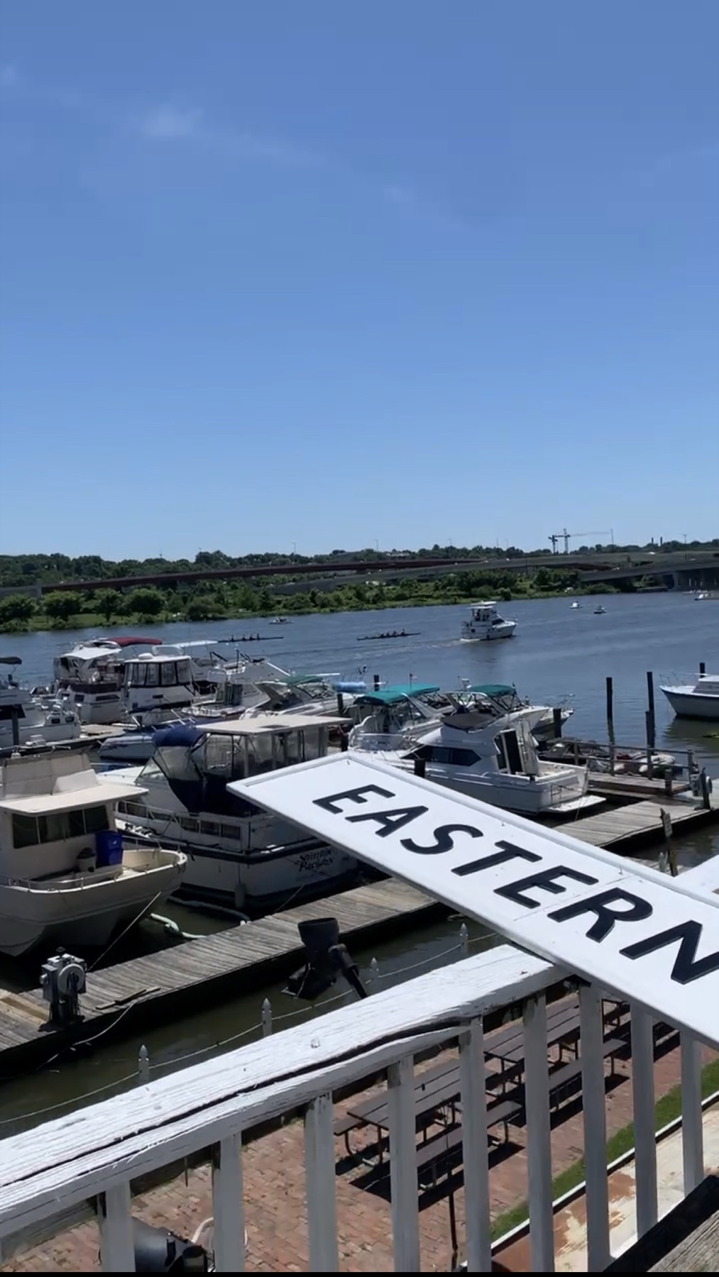 The marina and docks from the clubhouse balcony, rowers on the Anacostia