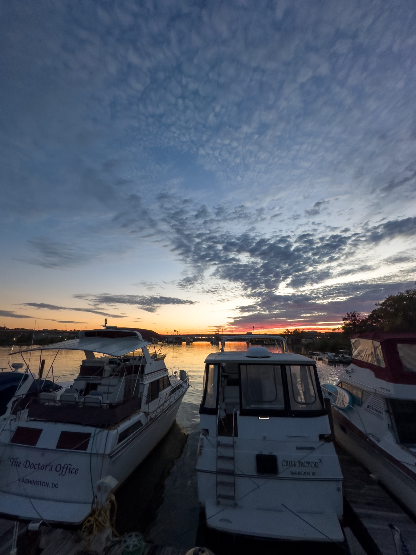 Boats at the dock under a fiery sunset on the Anacostia