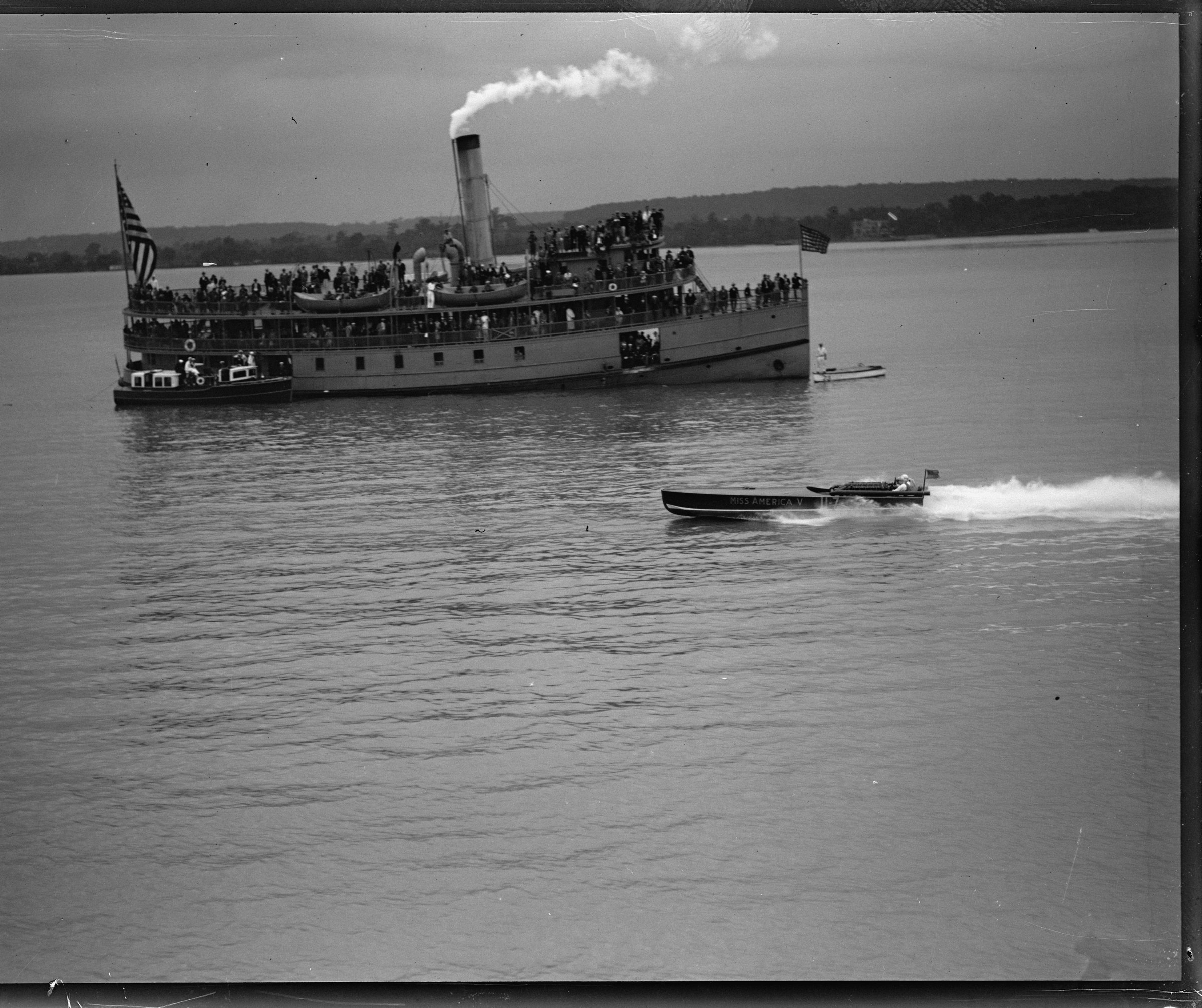 A racing speedboat on the Potomac in the club’s early years, a steamer beyond.