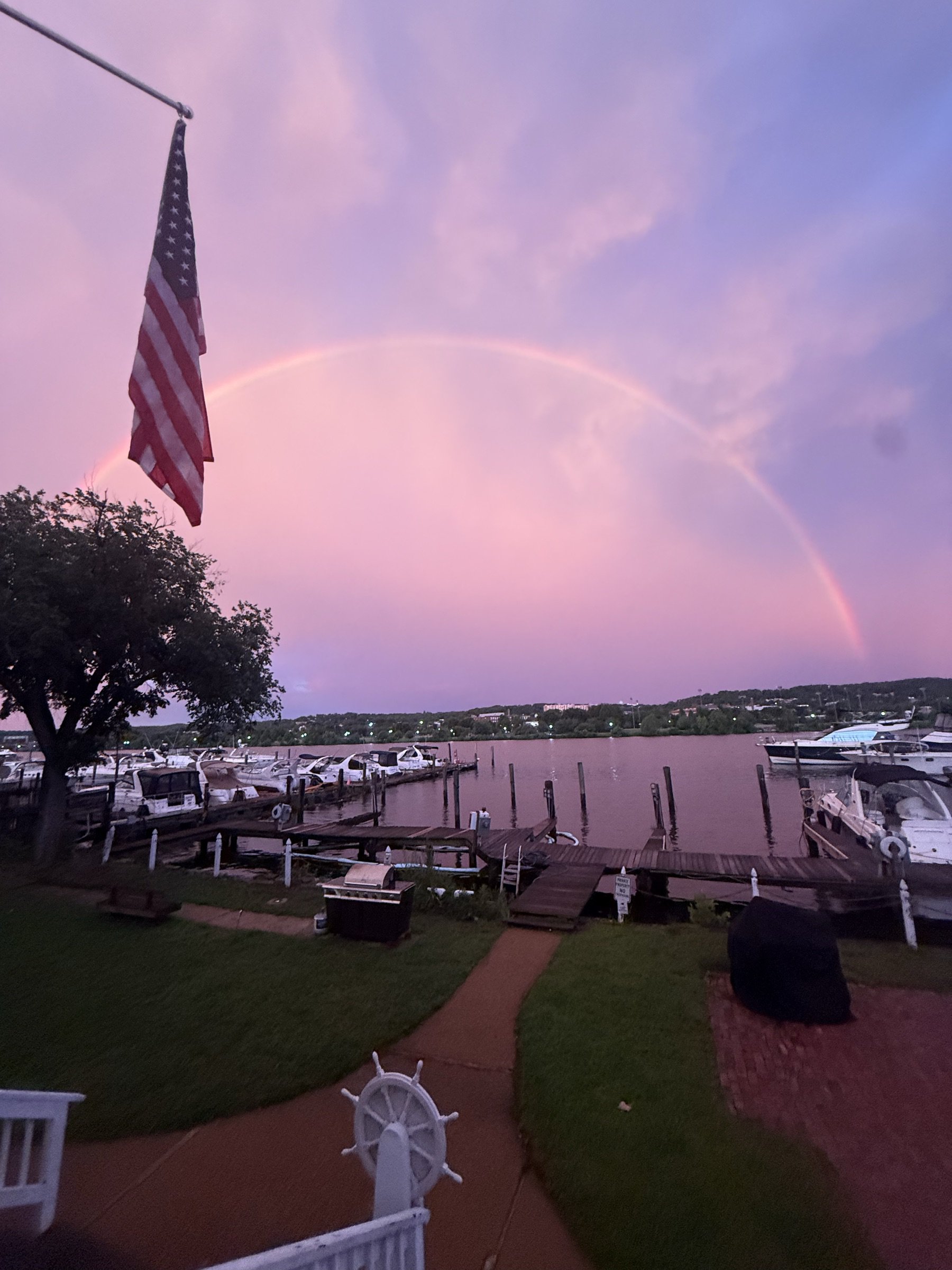Pink sunset rainbow over the marina
